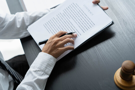 Lawyer reading legal document in office room