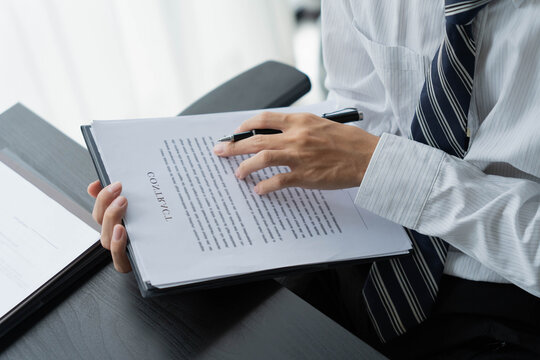 Lawyer reading legal document in office room