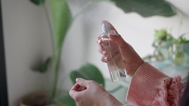 Woman Spraying Perfume on Her Wrist
