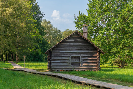Log building of a blacksmith shop from the village of Spas-Piskopets in the Novgorod Museum of Folk Wooden Architecture Vitoslavlitsy on a sunny summer day, Veliky Novgorod, Russia