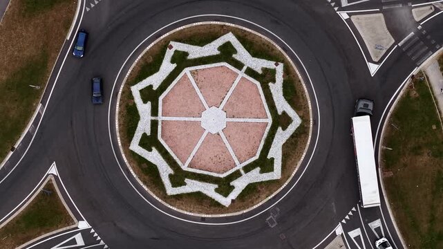 Top Down Drone Shot of Roundabout Traffic, Circle With Geometrical Symmetrical Star, Cinematic Aerial View