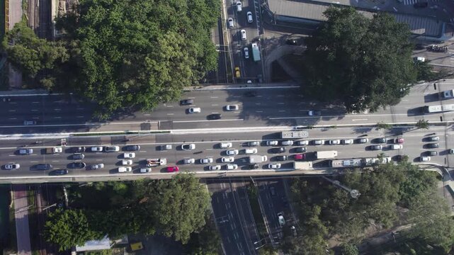 Drone pointing down over a cross bridge with traffic up and down