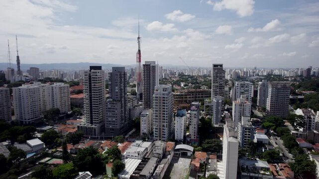 Orbital drone capturing S&atilde;o Paulo's Cityscape with a lot a buildings and a beautifull blue sky and clouds