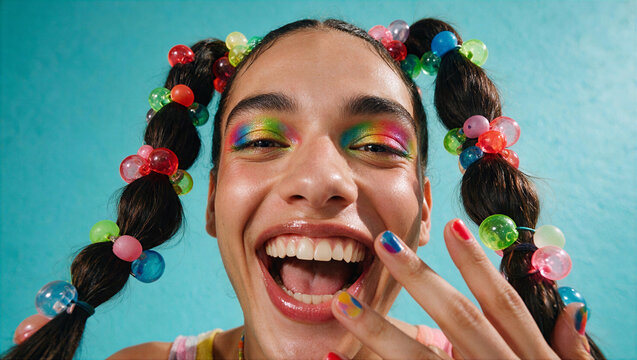 Portrait of a Gen Z person with vibrant makeup and colorful hair accessories. Close-up shot of young adult showcasing skincare-ready glowing skin a...