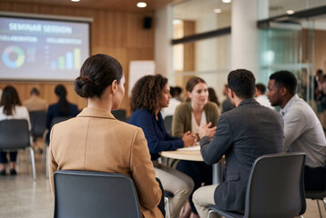 Fototapeta premium Diverse business professionals attending a corporate seminar session in a modern conference room