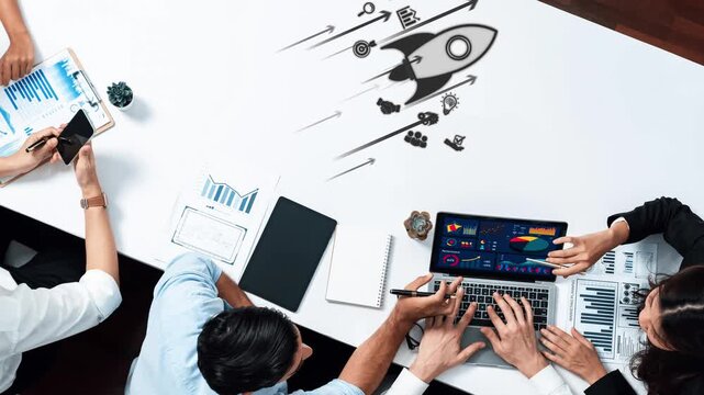 A dynamic business team collaborates in a modern workspace, utilizing technology and creative visuals to brainstorm innovative ideas for growth and success. Raster