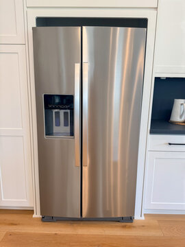 View of a modern brushed stainless steel side-by-side refrigerator.