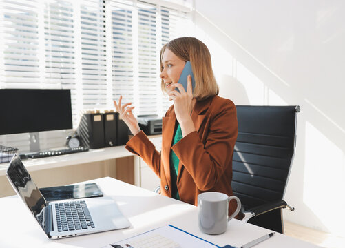 Woman smiling to herself as she works in an office