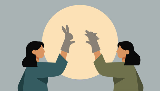 Artistic scene of two women using their hands to create animal shadow puppets of a rabbit and a wolf against a large glowing moon.
