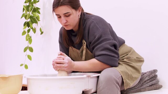 Artist molding. Sculptor craft. Professional woman potter shaping clay forming raw using electric wheel in creative artisan workplace.