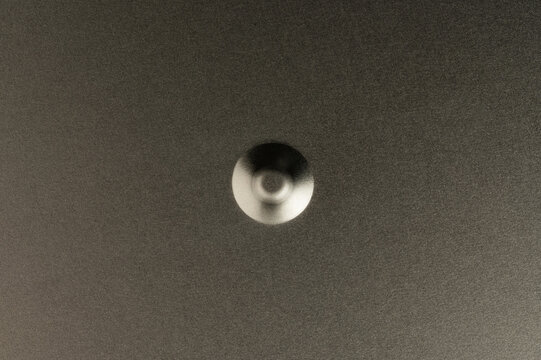 Round bump on grey metal flat surface