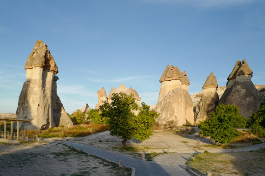 Unique Fairy Chimney Rock Formations in a Sunny Park Setting with Pathway