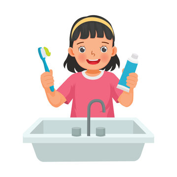 Little girl brushing teeth holding toothbrush and toothpaste
