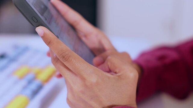 Smartphone hand touch screen finger close mobile device browsing online message communication indoors blurred background casual digital technology desk scene