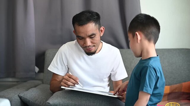 Father and son Magnetic Drawing Board is part of a warm family lifestyle at home.