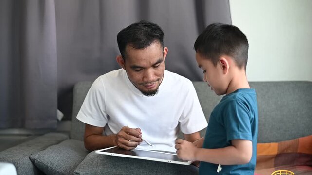 Father and son Magnetic Drawing Board practice writing and reading through play.