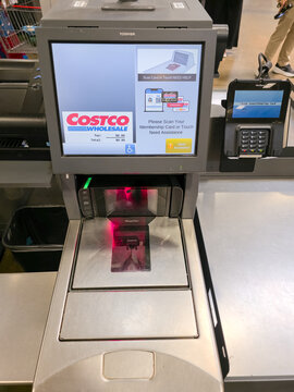 Costco self-checkout station featuring scanner and card reader