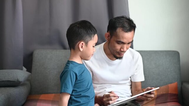 Father and son Magnetic Drawing Board practice writing and reading through play.