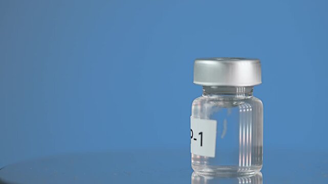 Hopeful glass vial containing clear glp1 medicine injection liquid offers secure scientific treatment and modern health solution on blue background