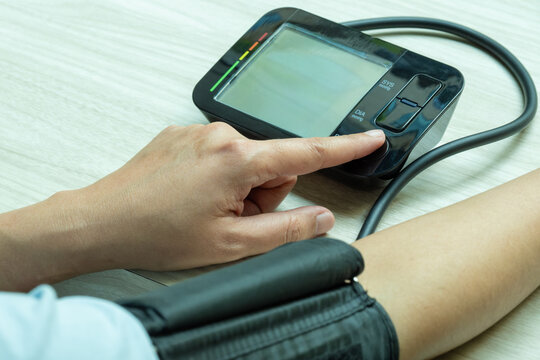 Woman check blood pressure monitor and heart rate monitor with digital pressure gauge. Health care and Medical concept	
