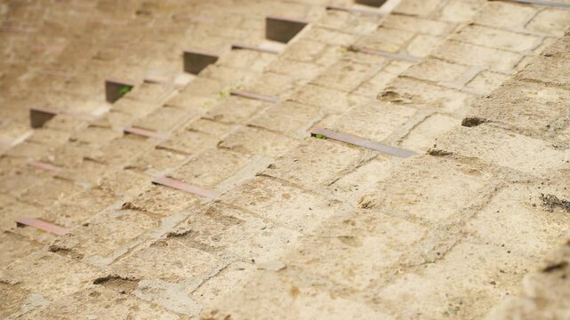 Stone steps of an ancient amphitheater seating area in sunny weather.