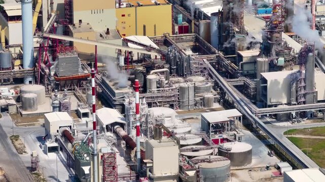 Industrial pulp mill complex with smoking chimneys processing eucalyptus. Aerial view of the facility for cellulose production and bioenergy
