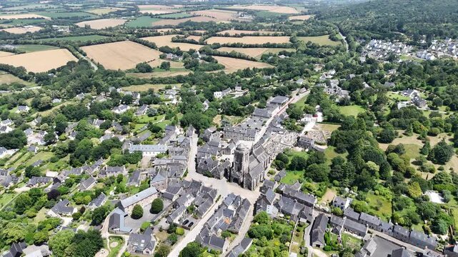 Pull back drone aerial reverse reveal Locronan medieval village Brittany France
