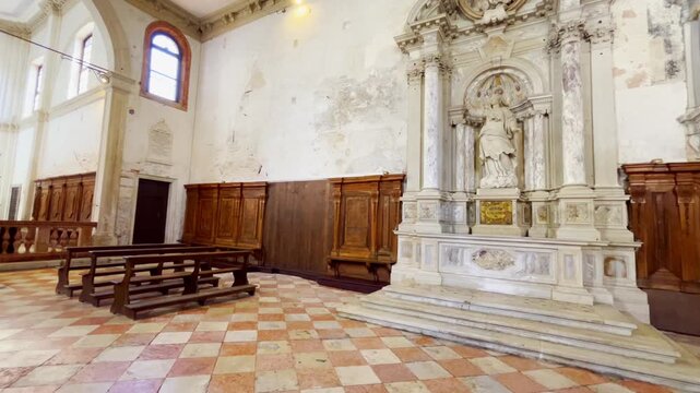 Continuous motion footage of the interior of Sant'Andrea della Zirada featuring religious architecture and decorative elements in Venice, Italy