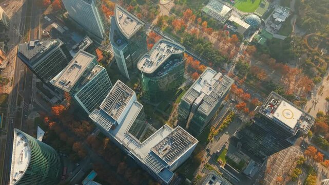 Aerial orbit establishing the modern buildings of Nueva Las Condes in Santiago, Chile, with autumn trees and a light mist