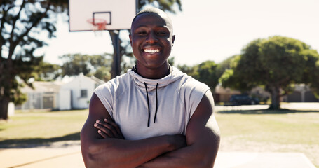 Pride, portrait or man on basketball court with arms crossed, fitness hobby or practice on weekend break. Active, happy or black person with confidence, hoop sport or training session in outdoor game © peopleimages.com