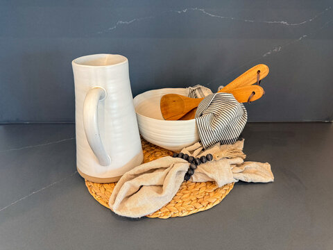 Rustic Handmade Ceramic Pitcher and Serving Bowl with wooden salad servers and striped tea towel Kitchen Still Life.