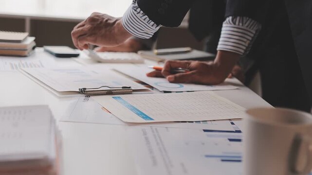 corporate, finance, budgeting, accounting, document, revenue, expenses, profit, audit, strategy, Person using calculator and reviewing financial documents for accounting and budget planning.