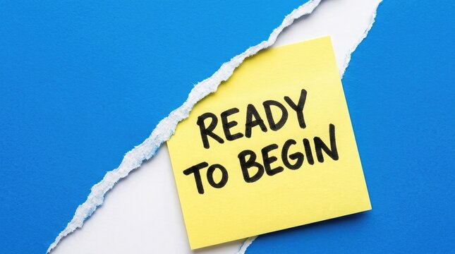 Ready to begin message on yellow sticky note with torn paper background