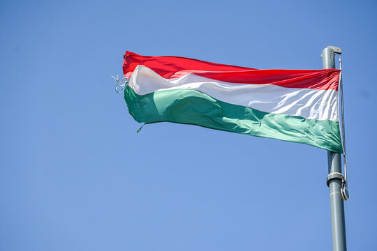 Hungarian National Flag Waving in Blue Sky