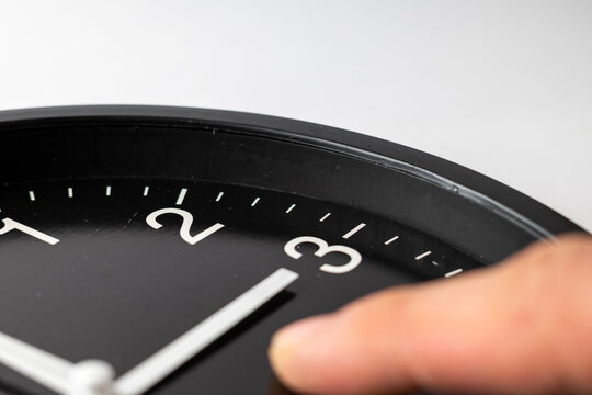 Hand Adjusting Analog Clock for Daylight Saving Time