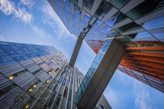 Dynamic perspective of futuristic buildings from Google and bridges under a cloudy sky, Docklands Dublin, Ireland