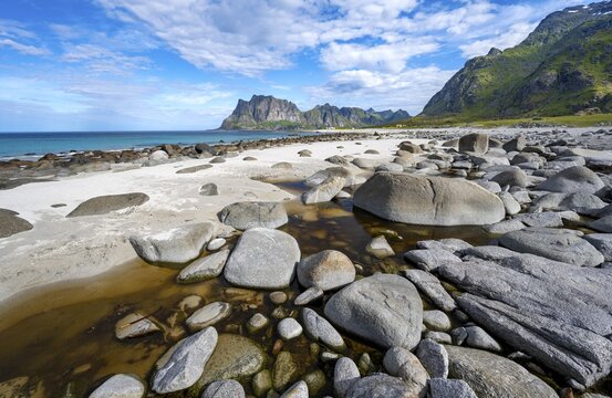 Coast and mountains, stones on the sandy beach of Uttakleiv, Vestv&aring;g&oslash;ya, Lofoten, Nordland, Norway