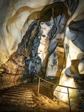 One person with headtorch is standing and exploring Magura cave textures.Batumi.Georgia