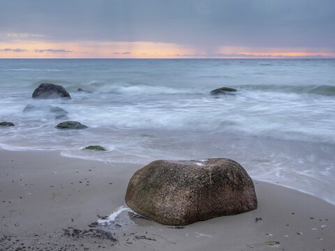Morning atmosphere on the Baltic Sea, large boulders on the beach, dark clouds and rain showers on the horizon, Cape Arkona, R&uuml;gen Island, Mecklenburg-Western Pomerania, Germany
