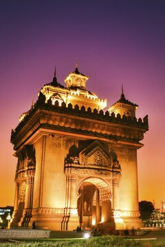Vientiane, Laos - 15th february, 2025: Patuxai Victory Monument in Vientiane, Laos. The illuminated arch glows golden with purple blue hour sky at sunset