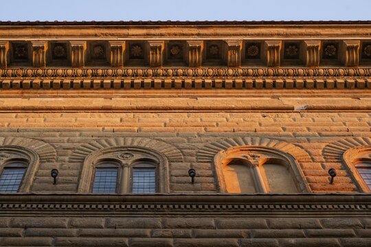 Fa&ccedil;ade of Palazzo Strozzi with intricately crafted roof cornice, warm evening light, old town, Florence, Tuscany, Italy