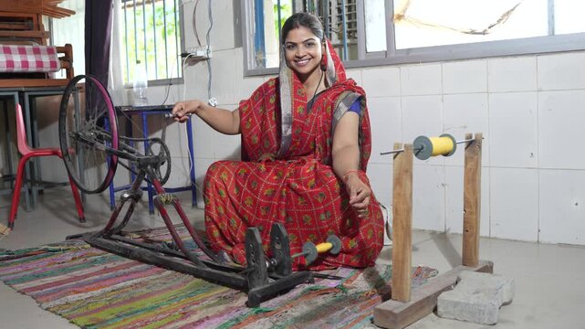 Indian woman using traditional charkha spinning wheel, transforming raw cotton into fine thread for weaving handmade textiles. Employment and Skill india. Women Empowerment