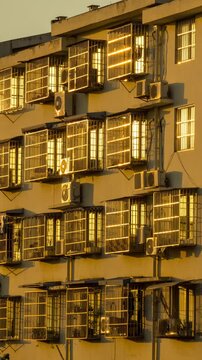 Houses are heavily fortified with lots of security window grilles showing anti-theft precautions on civilian dwellings, and the building walls are densely packed with air conditioning outdoor units.