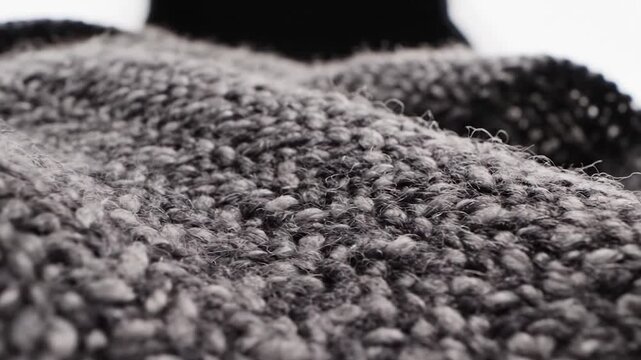 Grey knitted wool fabric texture close up.