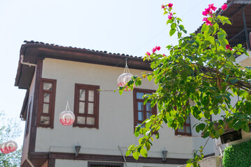 Fototapeta premium White Ottoman House with Hanging Lanterns and Bougainvillea at Kaleici