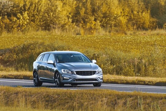 Compact hatchback automobile cruising down rural road