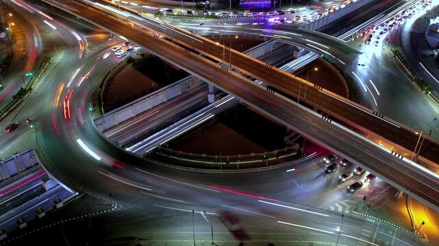 Intersection view above , Expressway top view, Road traffic an important infrastructure, car traffic transportation above intersection road in city night of advanced innovation, financial technology