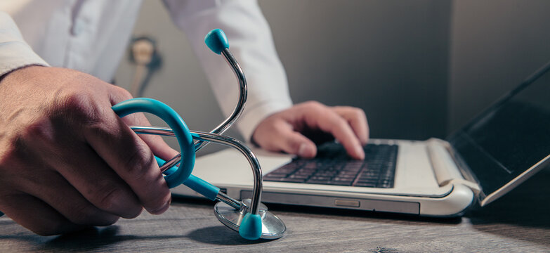 Doctor using a stethoscope to measure blood pressure. Healthcare and medical concept.