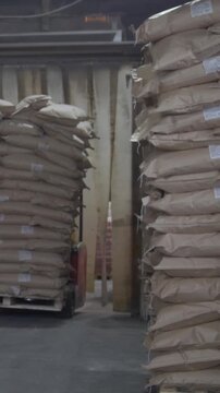 Loaders transport pallet with boxes on industrial warehouse