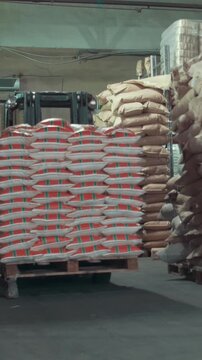 Working autoloader moving goods in industrial warehouse